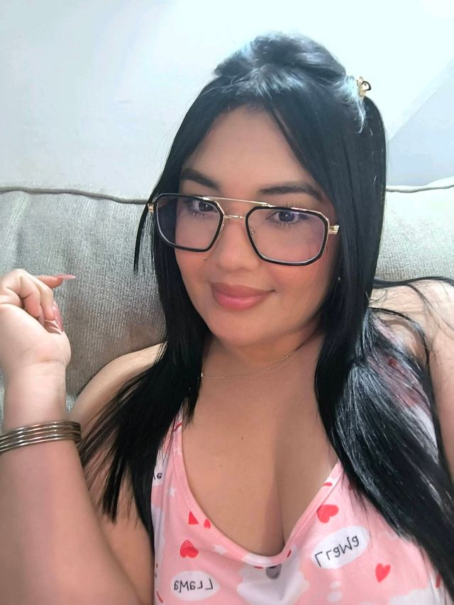 Woman timing how fast video chat sites connect while holding a phone and laptop